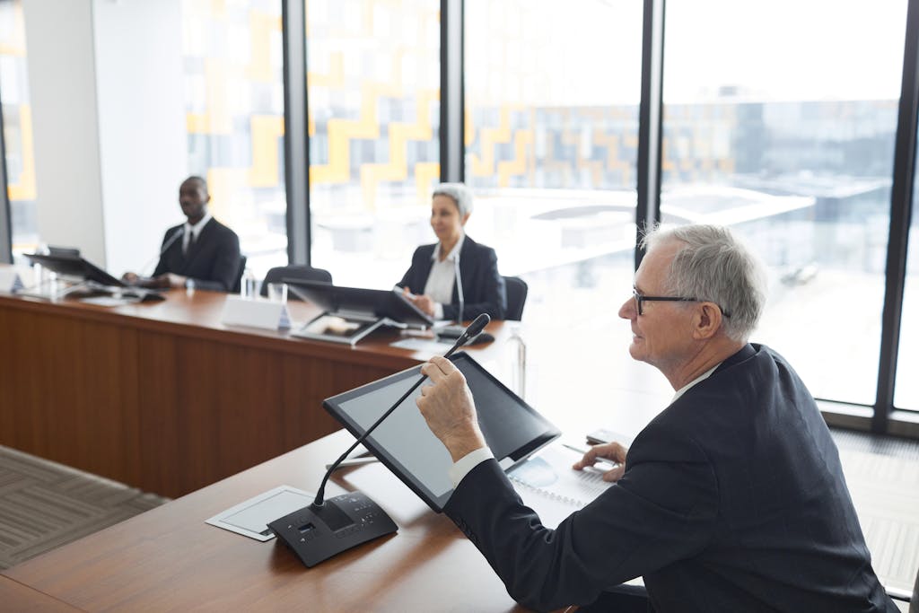 Business professionals engaged in a conference meeting, discussing strategy and cooperation.